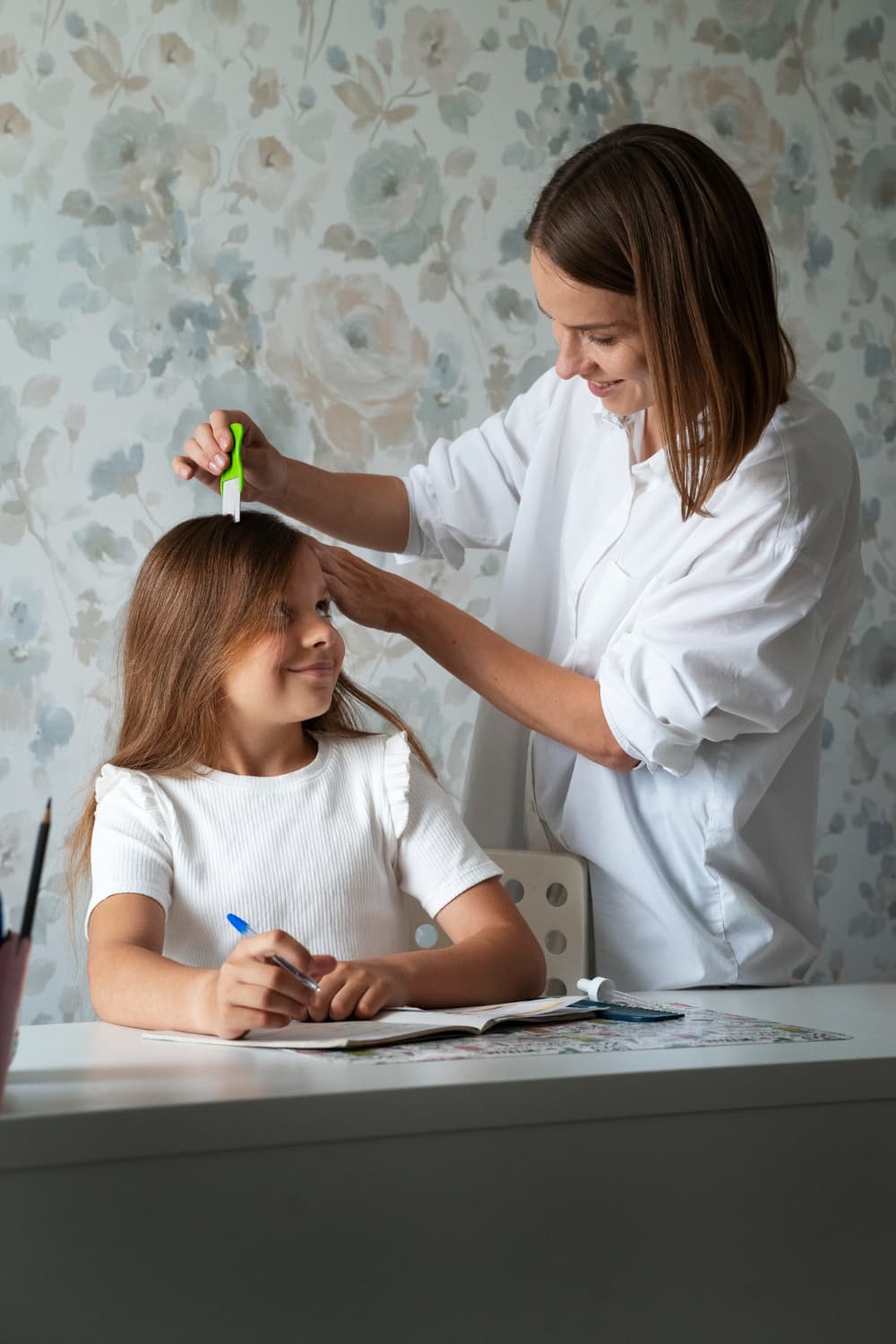 Checking a child’s hair with a lice comb at home
